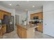 Bright kitchen with stainless appliances, tile flooring and a functional center island at 1650 S Crismon Rd # 63, Mesa, AZ 85209