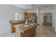 Charming kitchen featuring a functional island with seating, tile floors, and stainless appliances at 1650 S Crismon Rd # 63, Mesa, AZ 85209