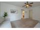 Open living room with bull art, archways, ceiling fan, and plush seating at 1650 S Crismon Rd # 63, Mesa, AZ 85209