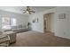 Cozy living room with neutral walls, fan, carpet, a bull painting and comfortable sofa set at 1650 S Crismon Rd # 63, Mesa, AZ 85209