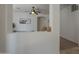 Open concept shows decorative opening with decorative bull artwork and ceiling fan in the living room at 1650 S Crismon Rd # 63, Mesa, AZ 85209