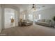 Spacious living room featuring carpet, neutral sofas, with arches looking into other rooms at 1650 S Crismon Rd # 63, Mesa, AZ 85209