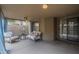 This covered patio features outdoor seating, neutral tones, and access to the home via sliding glass door at 1650 S Crismon Rd # 63, Mesa, AZ 85209