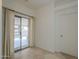 Bright room with neutral walls, tile floors and sliding glass doors to access backyard patio at 1650 S Crismon Rd # 63, Mesa, AZ 85209
