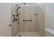 Bathroom shower featuring new shower head, fixtures, grab bar and tiled surround at 1650 S Crismon Rd # 63, Mesa, AZ 85209