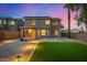 Backyard with grass area, a paved patio, desert landscaping, and solar panels at 1655 W Stanford Ave, Gilbert, AZ 85233