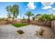 A fully landscaped backyard provides a patio with pavers, green grass, and mature landscaping at 1655 W Stanford Ave, Gilbert, AZ 85233