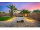 Beautiful backyard with pavers, green grass, desert landscaping, and a mature palm tree at 1655 W Stanford Ave, Gilbert, AZ 85233