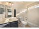 Bathroom with vanity, toilet, and tub/shower combo with bright, natural lighting at 1655 W Stanford Ave, Gilbert, AZ 85233