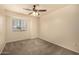 Neutral bedroom with carpeted floor and a ceiling fan with lights at 1655 W Stanford Ave, Gilbert, AZ 85233