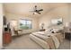 Serene bedroom featuring neutral tones, a ceiling fan, and a comfortable bed, offering a relaxing retreat at 1655 W Stanford Ave, Gilbert, AZ 85233