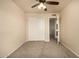 Clean bedroom features carpet, ceiling fan, and a closet with sliding doors at 1655 W Stanford Ave, Gilbert, AZ 85233