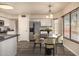 Dining room featuring a table with seating for four, stainless steel appliances, and bright natural light at 1655 W Stanford Ave, Gilbert, AZ 85233