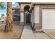 Inviting entryway with a black front door, arched window, and desert landscaping at 1655 W Stanford Ave, Gilbert, AZ 85233