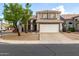 Charming two-story home showcasing a wide driveway, desert landscaping, and neutral tones at 1655 W Stanford Ave, Gilbert, AZ 85233