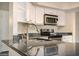 Modern kitchen featuring stainless steel appliances, granite countertops, ample cabinetry, and modern fixtures at 1655 W Stanford Ave, Gilbert, AZ 85233