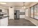 Kitchen featuring stainless steel appliances, white cabinetry, wood-style flooring, and breakfast area at 1655 W Stanford Ave, Gilbert, AZ 85233