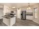 Well-equipped kitchen featuring white cabinets, stainless steel appliances, granite countertops, and wood-style flooring at 1655 W Stanford Ave, Gilbert, AZ 85233
