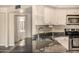 Well-lit kitchen featuring a stainless steel sink, granite countertops, a view of the appliances, and modern fixtures at 1655 W Stanford Ave, Gilbert, AZ 85233