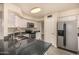 Bright kitchen with stainless steel appliances, white cabinetry, granite countertops, and modern fixtures at 1655 W Stanford Ave, Gilbert, AZ 85233