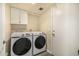 Functional laundry room with modern white Samsung washer and dryer at 1655 W Stanford Ave, Gilbert, AZ 85233