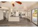 Open-concept space showcasing the kitchen, stairwell, tile flooring, and a view of the backyard through a sliding glass door at 1655 W Stanford Ave, Gilbert, AZ 85233