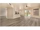 Bright living room featuring light-colored walls, ceiling fan, wood-style flooring, and sliding glass doors to the backyard at 1655 W Stanford Ave, Gilbert, AZ 85233