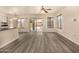 Open living space featuring wood-look floors, a ceiling fan, and a backyard view at 1655 W Stanford Ave, Gilbert, AZ 85233