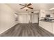 Open-concept living area featuring modern flooring, neutral paint, natural lighting, and a view into the kitchen at 1655 W Stanford Ave, Gilbert, AZ 85233