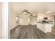 Open-concept living area with a ceiling fan, modern floors, and adjacent kitchen at 1655 W Stanford Ave, Gilbert, AZ 85233