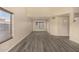 Open living room with wood-look floors, neutral walls, and plenty of natural light at 1655 W Stanford Ave, Gilbert, AZ 85233