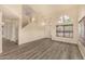 Bright living room featuring wood-look floors, high ceilings, and staircase at 1655 W Stanford Ave, Gilbert, AZ 85233