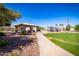 Community park featuring a covered picnic area, playground, and walking path with a backdrop of residential houses at 1655 W Stanford Ave, Gilbert, AZ 85233