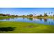 Waterfront views of a scenic pond and lush green spaces throughout the El Dorado Lakes community at 1655 W Stanford Ave, Gilbert, AZ 85233