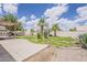 A backyard with a covered patio, a recreational vehicle, palm trees, and desert landscaping at 1660 E Zinnia St, Casa Grande, AZ 85122