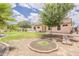 View of a backyard showing grass, desert landscaping, and a covered patio at 1660 E Zinnia St, Casa Grande, AZ 85122