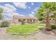A grassy backyard with desert landscaping, a covered patio, and an recreational vehicle in the back at 1660 E Zinnia St, Casa Grande, AZ 85122