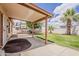 Covered patio overlooking the backyard featuring a grassy area, palm trees, and recreational vehicle at 1660 E Zinnia St, Casa Grande, AZ 85122