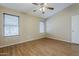 Bedroom with wood floors, two windows, and neutral walls at 1660 E Zinnia St, Casa Grande, AZ 85122