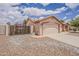 Charming single-story home featuring a two-car garage, stucco exterior, and tile roof at 1660 E Zinnia St, Casa Grande, AZ 85122