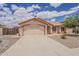 An inviting single-story home with a two-car garage and desert landscaping in the front yard at 1660 E Zinnia St, Casa Grande, AZ 85122