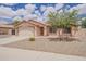 Charming home featuring a well-manicured front yard, a two-car garage, and desert landscaping at 1660 E Zinnia St, Casa Grande, AZ 85122