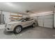 Spacious garage featuring an overhead door, shelving, and parking for one vehicle at 1660 E Zinnia St, Casa Grande, AZ 85122