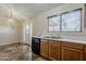View of a kitchen featuring a sink, window, dishwasher, and access to the dining area at 1660 E Zinnia St, Casa Grande, AZ 85122