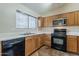 Functional kitchen equipped with wooden cabinets, microwave, gas range and dishwasher at 1660 E Zinnia St, Casa Grande, AZ 85122