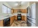 Bright kitchen featuring stainless steel appliances, wood cabinets, and light countertops at 1660 E Zinnia St, Casa Grande, AZ 85122