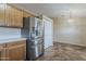 Bright kitchen area with stainless steel refrigerator and ample cabinet space at 1660 E Zinnia St, Casa Grande, AZ 85122