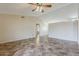 Spacious living room enhanced by a ceiling fan and neutral paint palette at 1660 E Zinnia St, Casa Grande, AZ 85122