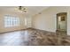 Inviting living room with ceiling fan, large window, and convenient access to the laundry room at 1660 E Zinnia St, Casa Grande, AZ 85122