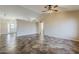 Open-concept living room features beautiful tile floors, a ceiling fan, and neutral paint at 1660 E Zinnia St, Casa Grande, AZ 85122